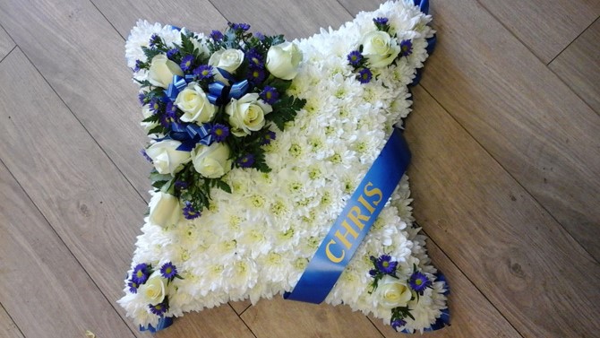 Cushion shaped funeral flowers white blue sash Bristol FCU1
