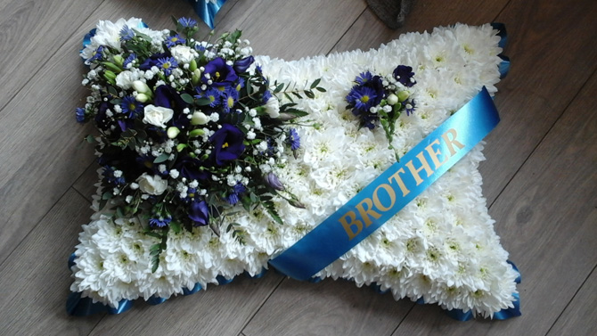 Pillow shaped funeral flowers brother sash white blue Bristol florist FPI1